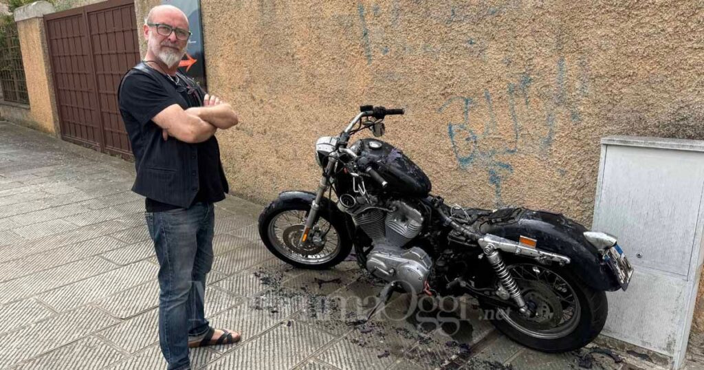 Il parrucchiere Salvatore Maione con la moto bruciata davanti al suo negozio in centro storico